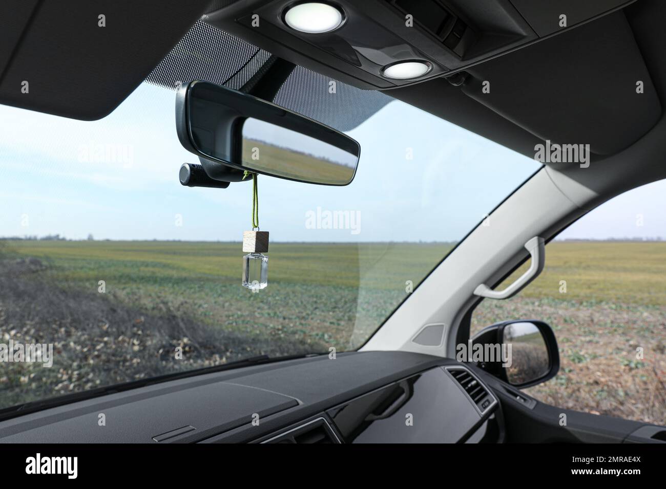 Air freshener hanging on rear view mirror in car Stock Photo Alamy