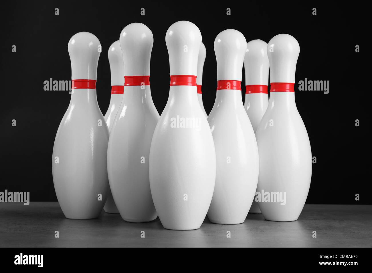 Set of bowling pins on grey stone table Stock Photo Alamy
