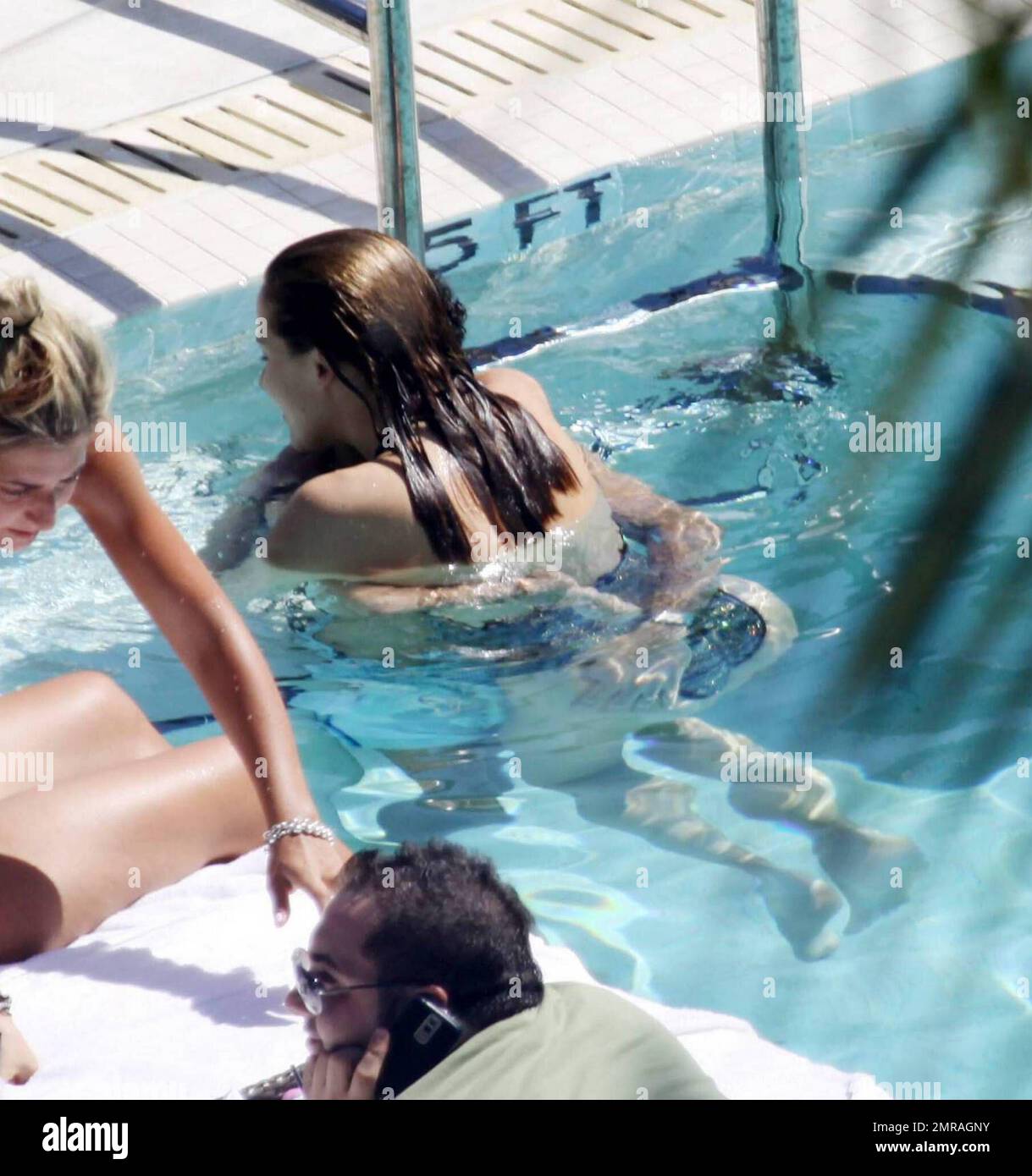 Exclusive!! French actor Jamel Debbouze and wife Melissa Theuriau kiss and cuddle in the pool at their exclusive Miami Beach hotel. Miami, FL 2/23/09 Stock Photo