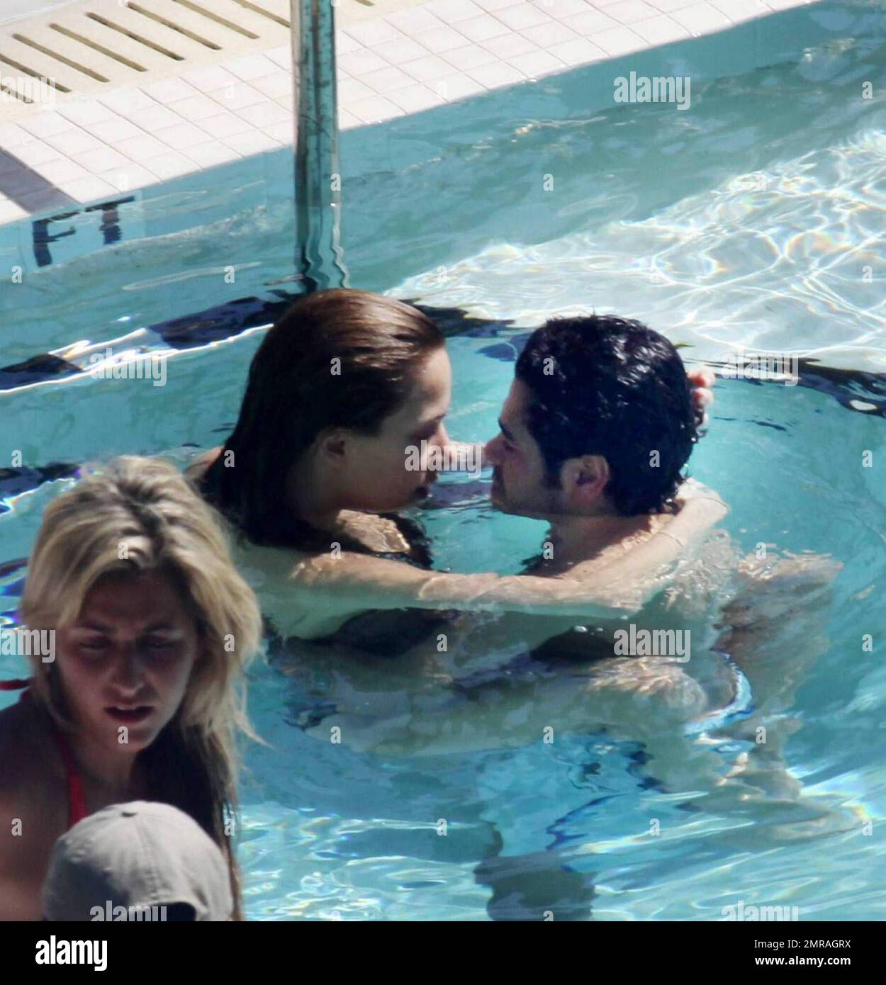 Exclusive!! French actor Jamel Debbouze and wife Melissa Theuriau kiss and cuddle in the pool at their exclusive Miami Beach hotel. Miami, FL 2/23/09 Stock Photo