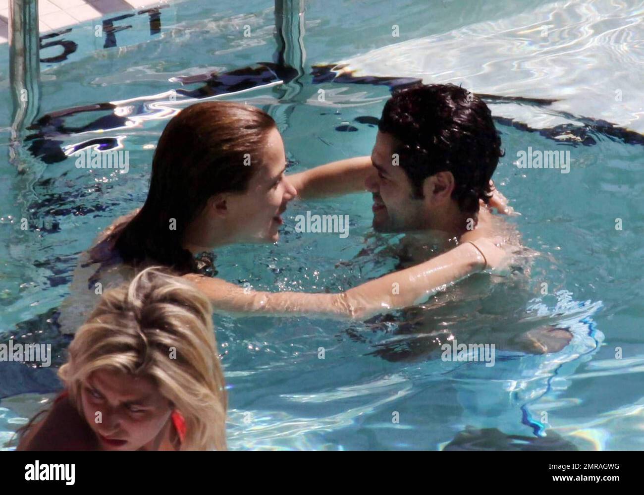 Exclusive!! French actor Jamel Debbouze and wife Melissa Theuriau kiss and cuddle in the pool at their exclusive Miami Beach hotel. Miami, FL 2/23/09 Stock Photo