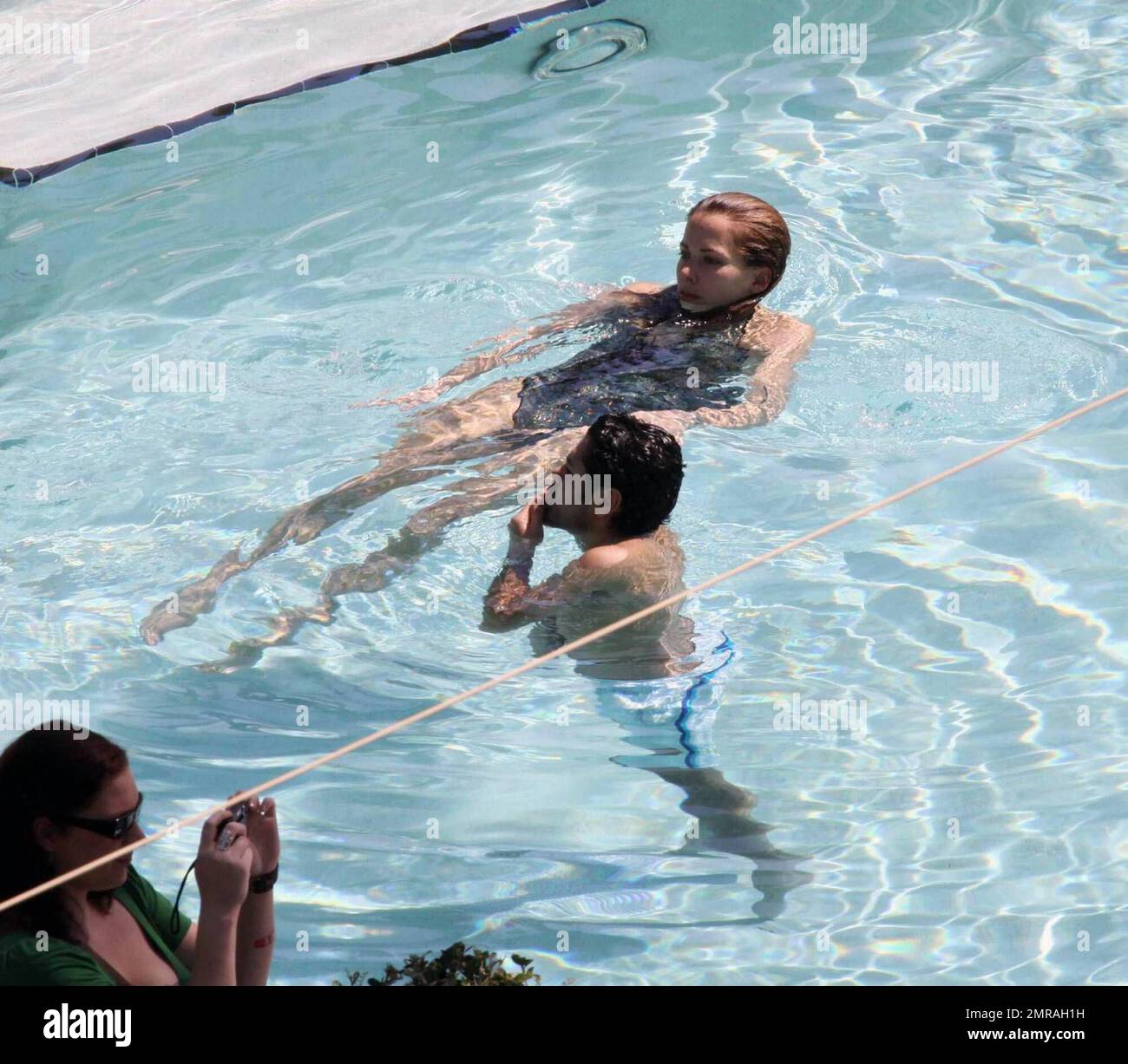 Exclusive!! French actor Jamel Debbouze and wife Melissa Theuriau kiss and cuddle in the pool at their exclusive Miami Beach hotel. Miami, FL 2/23/09 Stock Photo