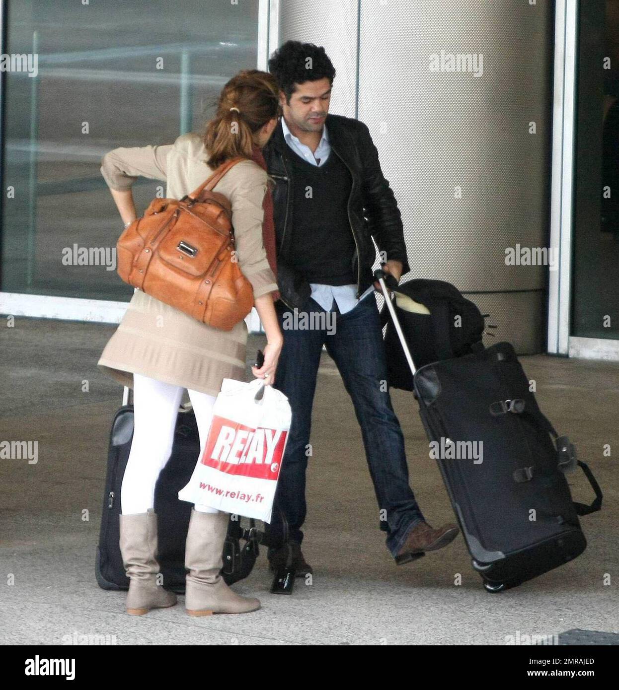 Exclusive!! French actor Jamel Debbouze and wife Melissa Theuriau arrive at Miami airport. The actor stopped to sign an autograph for a fan before jumping in a cab. Miami Beach, Florida. 2/23/09 Stock Photo
