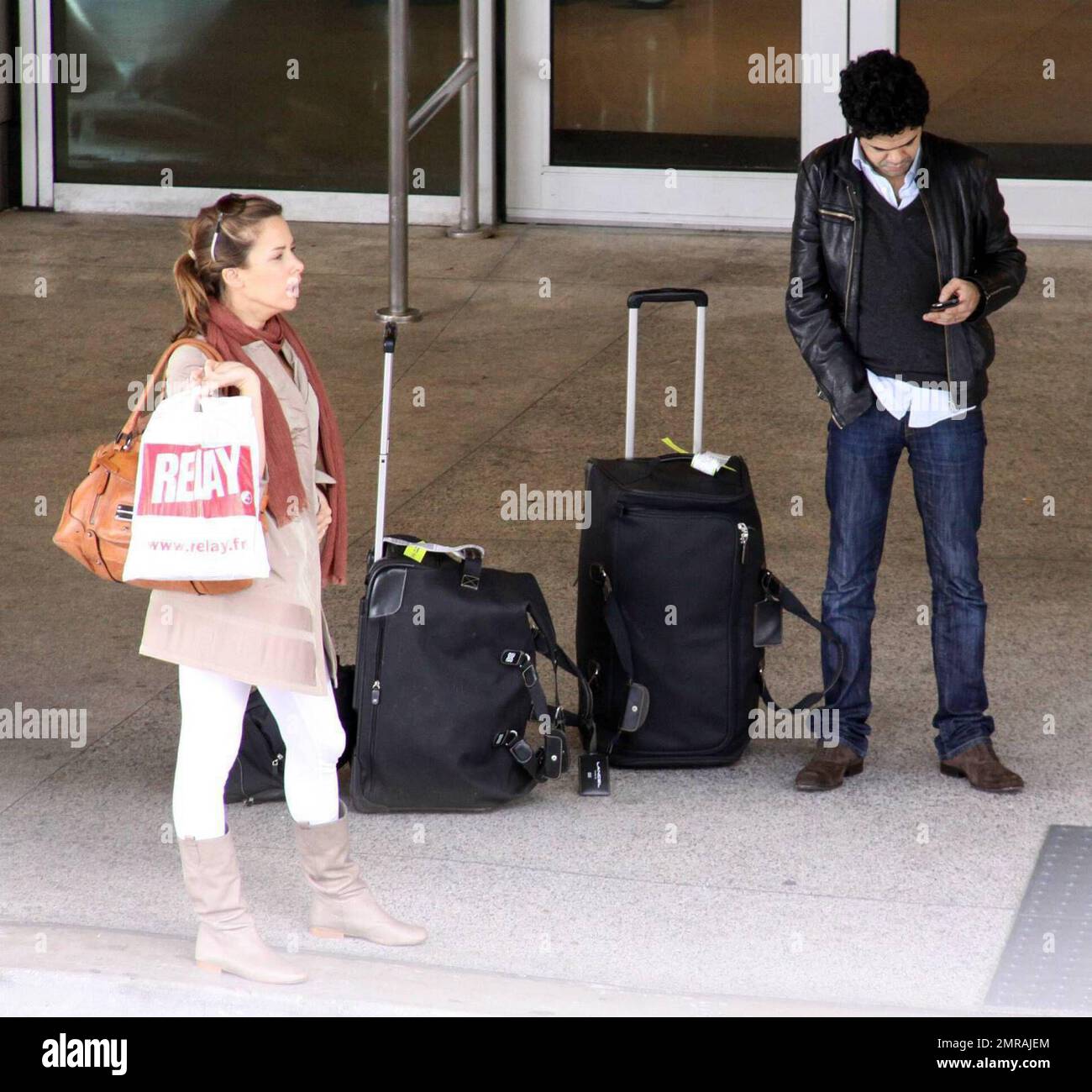 Exclusive!! French actor Jamel Debbouze and wife Melissa Theuriau arrive at Miami airport. The actor stopped to sign an autograph for a fan before jumping in a cab. Miami Beach, Florida. 2/23/09 Stock Photo