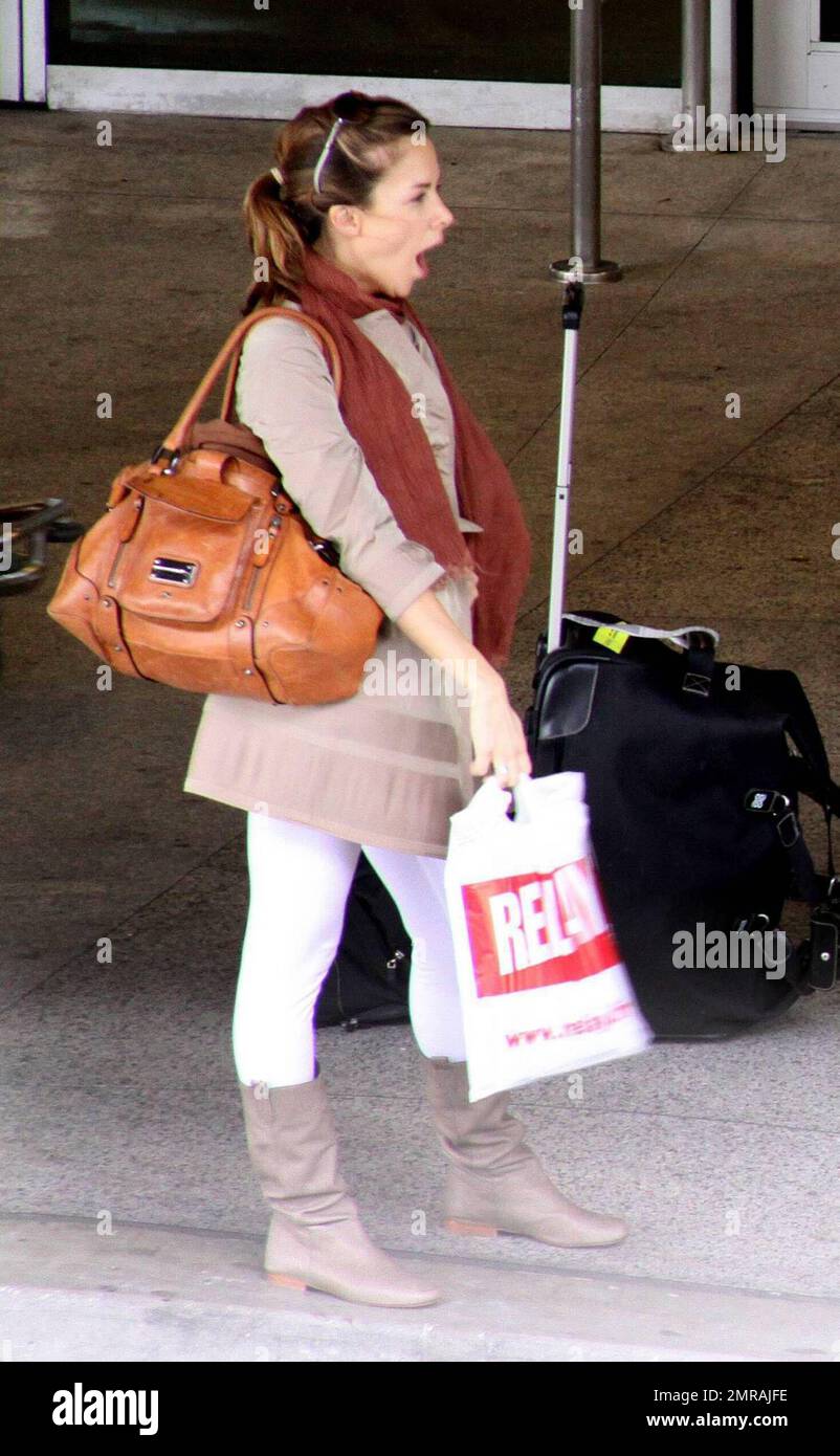 Exclusive!! French actor Jamel Debbouze and wife Melissa Theuriau arrive at Miami airport. The actor stopped to sign an autograph for a fan before jumping in a cab. Miami Beach, Florida. 2/23/09 Stock Photo