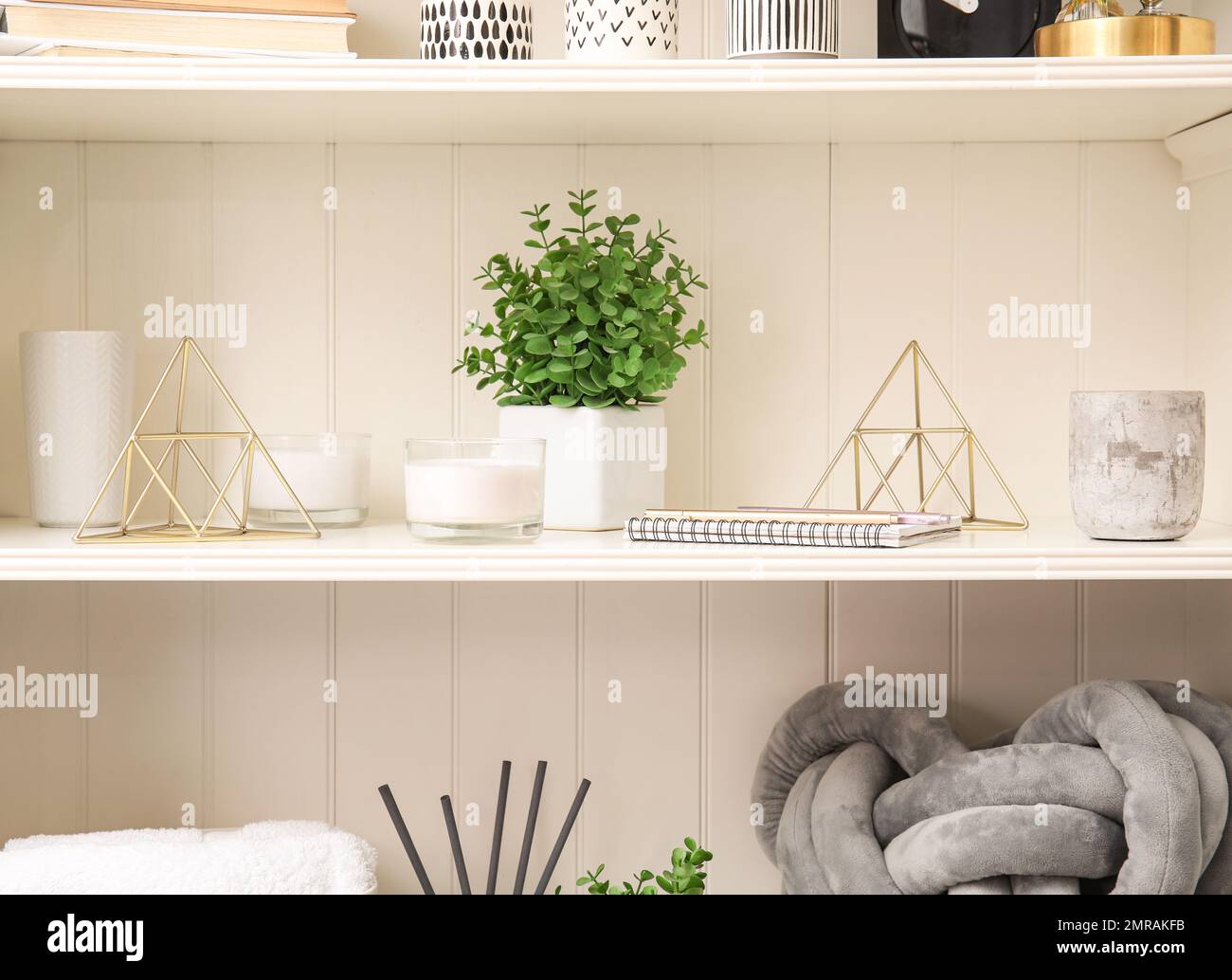 White shelving unit with plant and different decorative stuff Stock Photo