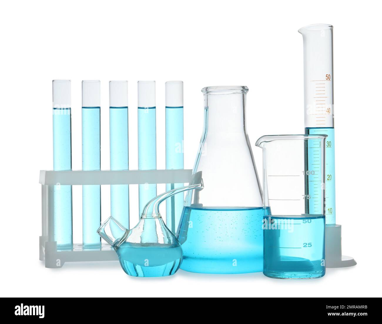 Different laboratory glassware with light blue liquid isolated on white ...