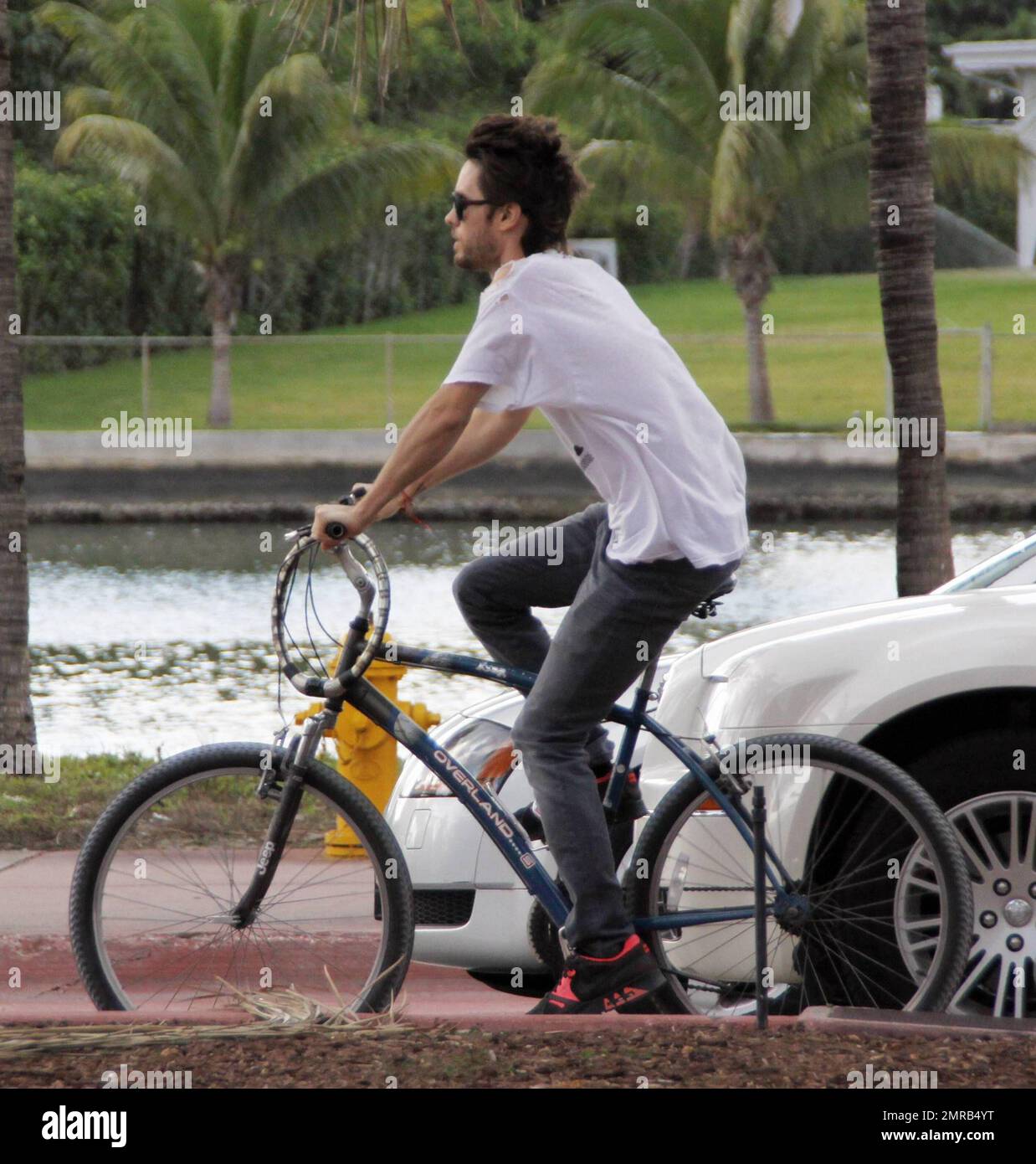EXCLUSIVE!! Actor turned rock star, Jared Leto, takes a ride on a bike  during a trip to South Beach for New Years. Leto, wearing a t-shirt full of  holes and grey skinny