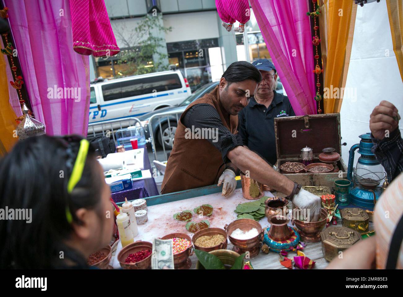 "Mr. Paanwala" Mehul Patel makes paan, a combination of nuts and pastes folded into a betel leaf, during the Diwali festival at a Times Square celebration Saturday, Oct. 7, 2017, in New York. In addition to dance and music performances, Indian foods and clothing were on offer during the event. (AP Photo/Kevin Hagen) Stock Photo