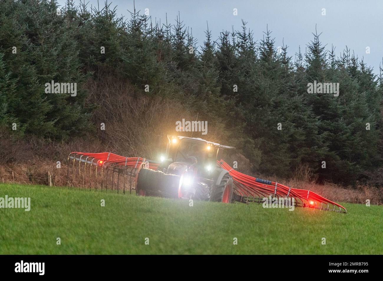 Clounkeen, West Cork, Ireland. 31st Jan, 2023. Dennehy Harvesting Contractors spread slurry on farmland in Clounkeen on the last day of January. The Ballyhooley based contractors fill a mobile slurry tank via New Rock 4000 slurry tankers and pump the slurry to a dribble bar spreader. This form of slurry spreading helps to cut emissions, which is better for the environment. Credit: AG News/Alamy Live News Stock Photo