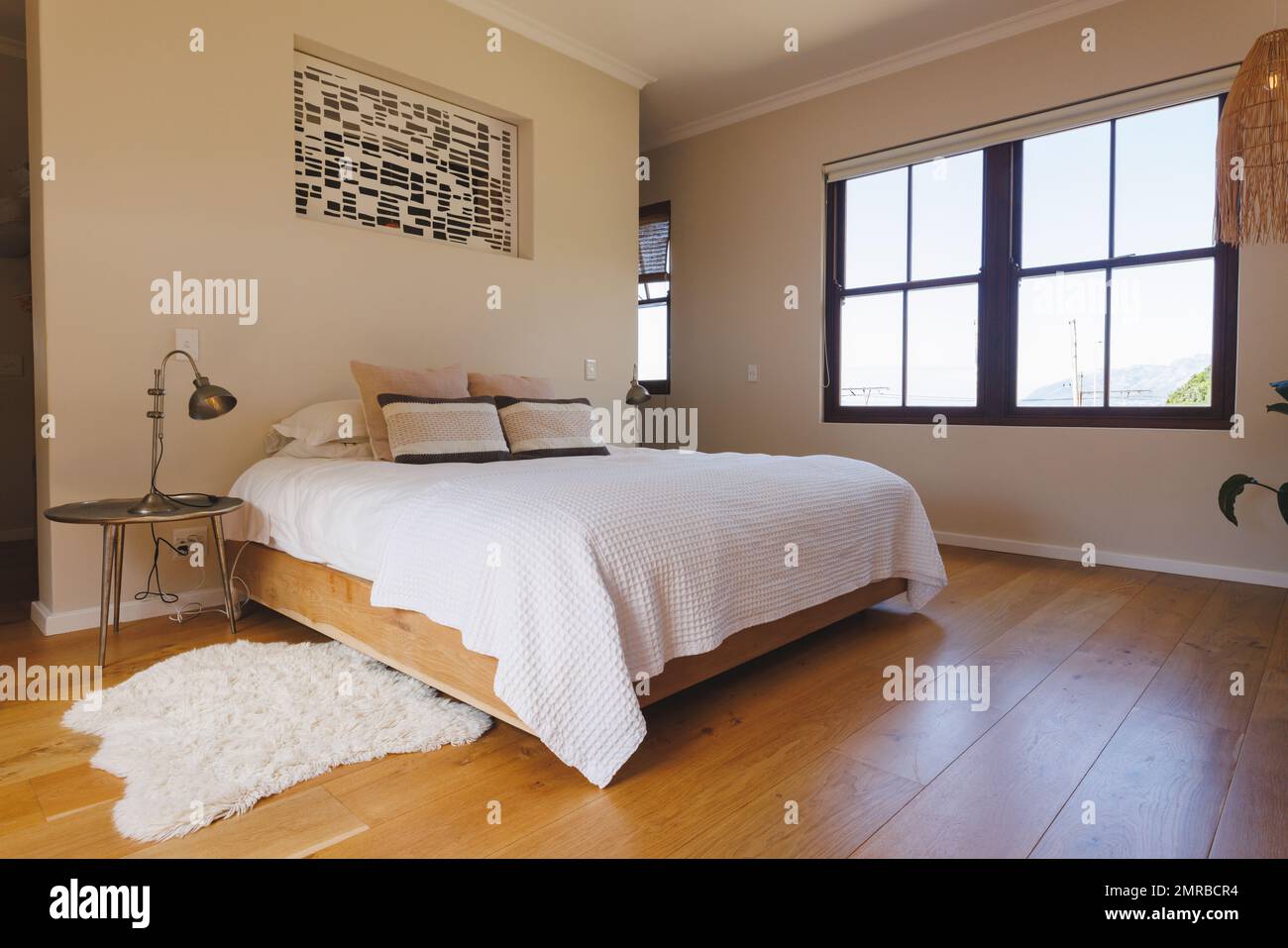 General view of luxury bedroom interior with bed and window Stock Photo