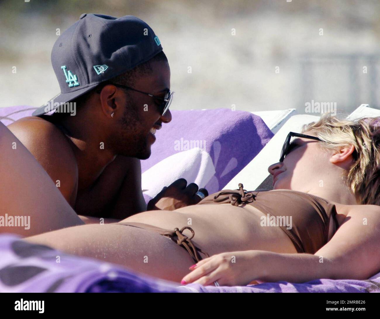 JLS singer JB Gill shares a tender moment with girlfriend Chloe Tangney while relaxing in the warm South Florida sun on Miami Beach. JB and the rest of the band are celebrating the end of their sold-out UK arena tour with a much-deserved holiday. Miami Beach, FL. 2/4/11. Stock Photo