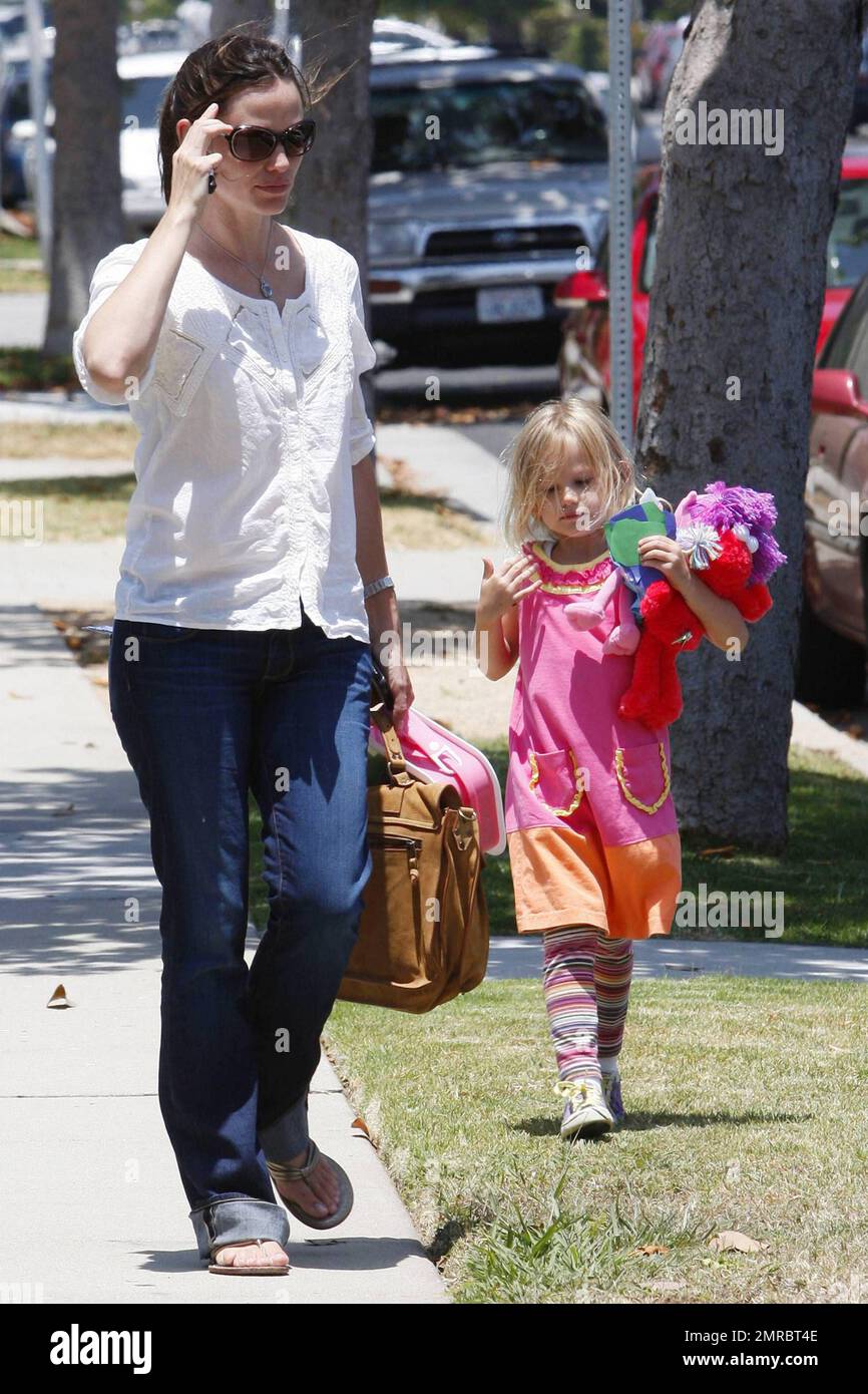 Actress Jennifer Garner, whose rep recently denied that the actress is pregnant picks colorfully dressed daughter Violet up from school.  The mother of two and wife of actor Ben Affleck toted a briefcase satchel, wore her hair in a casual ponytail and later carried Violet and her lunch bag.  One of Garner's latest films 'Butter', which she co-produced, is set for a 2011 release.  Los Angeles, CA. 06/22/10. . Stock Photo