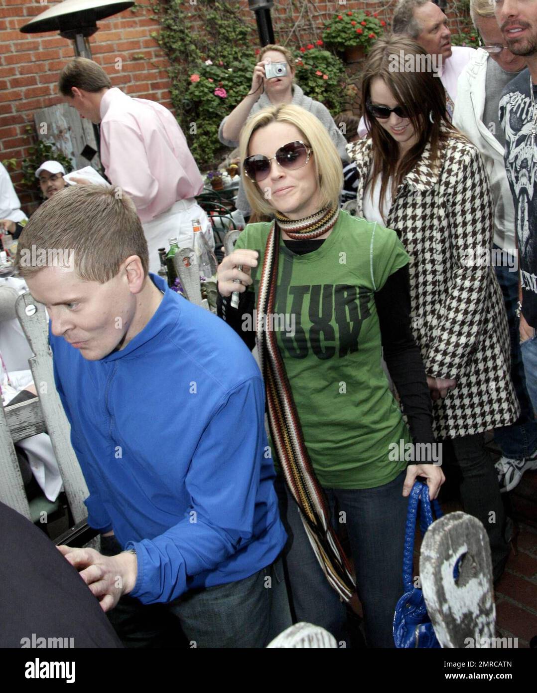 Jenny McCarthy and her family lunch at the Ivy. The group was all smiles as they waited for the car to be brought around and Jenny posed for photos with fans in the interim. Recently a friend had joked that Jenny was pregnant but by the looks of her flat tummy, it can't be true. Los Angeles, Ca. 3/1/08. Stock Photo