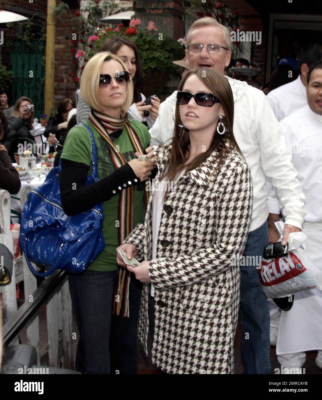Jenny McCarthy and her family lunch at the Ivy. The group was all smiles as they waited for the car to be brought around and Jenny posed for photos with fans in the interim. Recently a friend had joked that Jenny was pregnant but by the looks of her flat tummy, it can't be true. Los Angeles, Ca. 3/1/08. Stock Photo