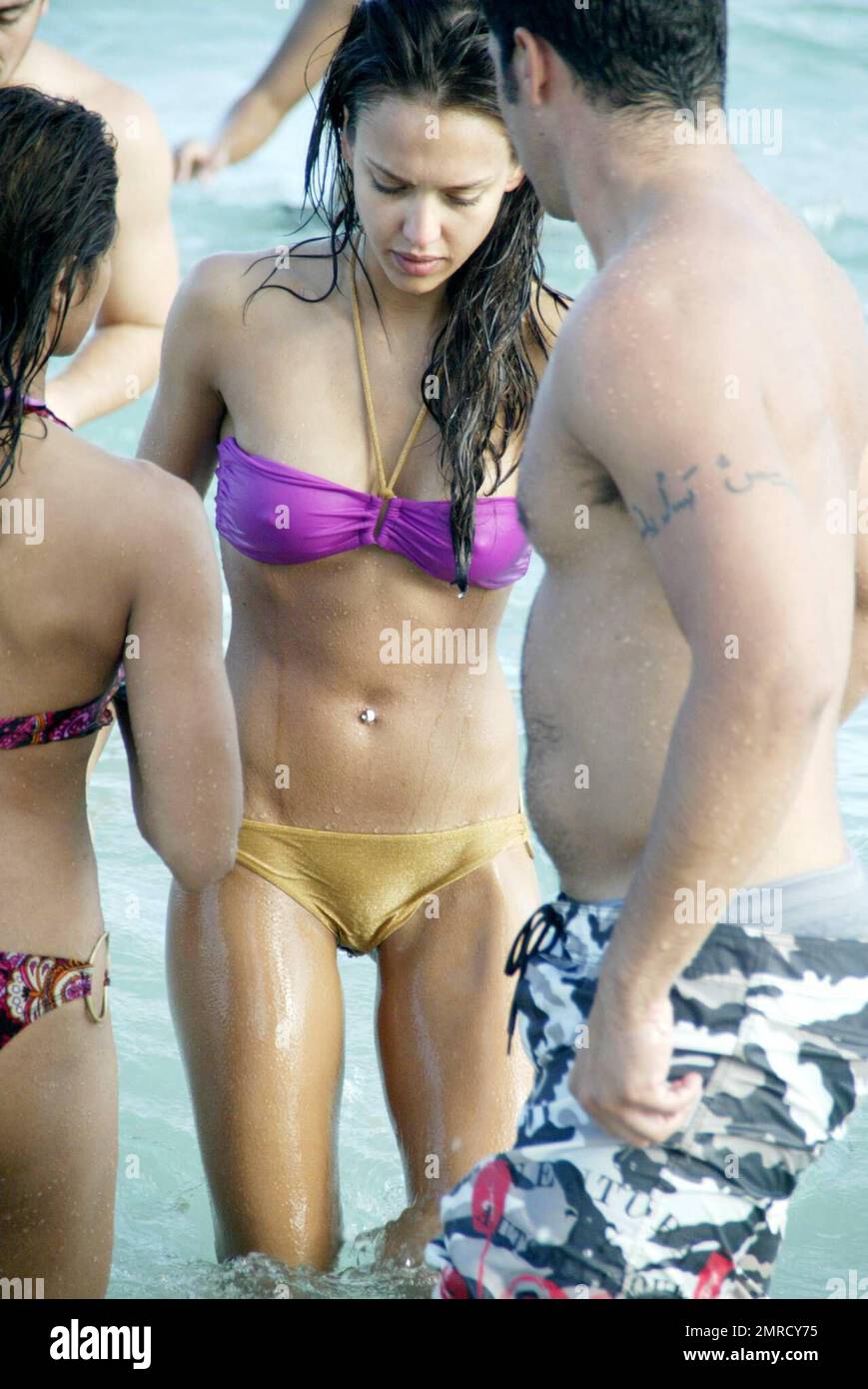 Jessica Alba and fiance Cash Warren spend New Year's Day on Miami Beach The  couple cuddled and also played football with friends in the ocean.  Paparazzi attention was so intense that the