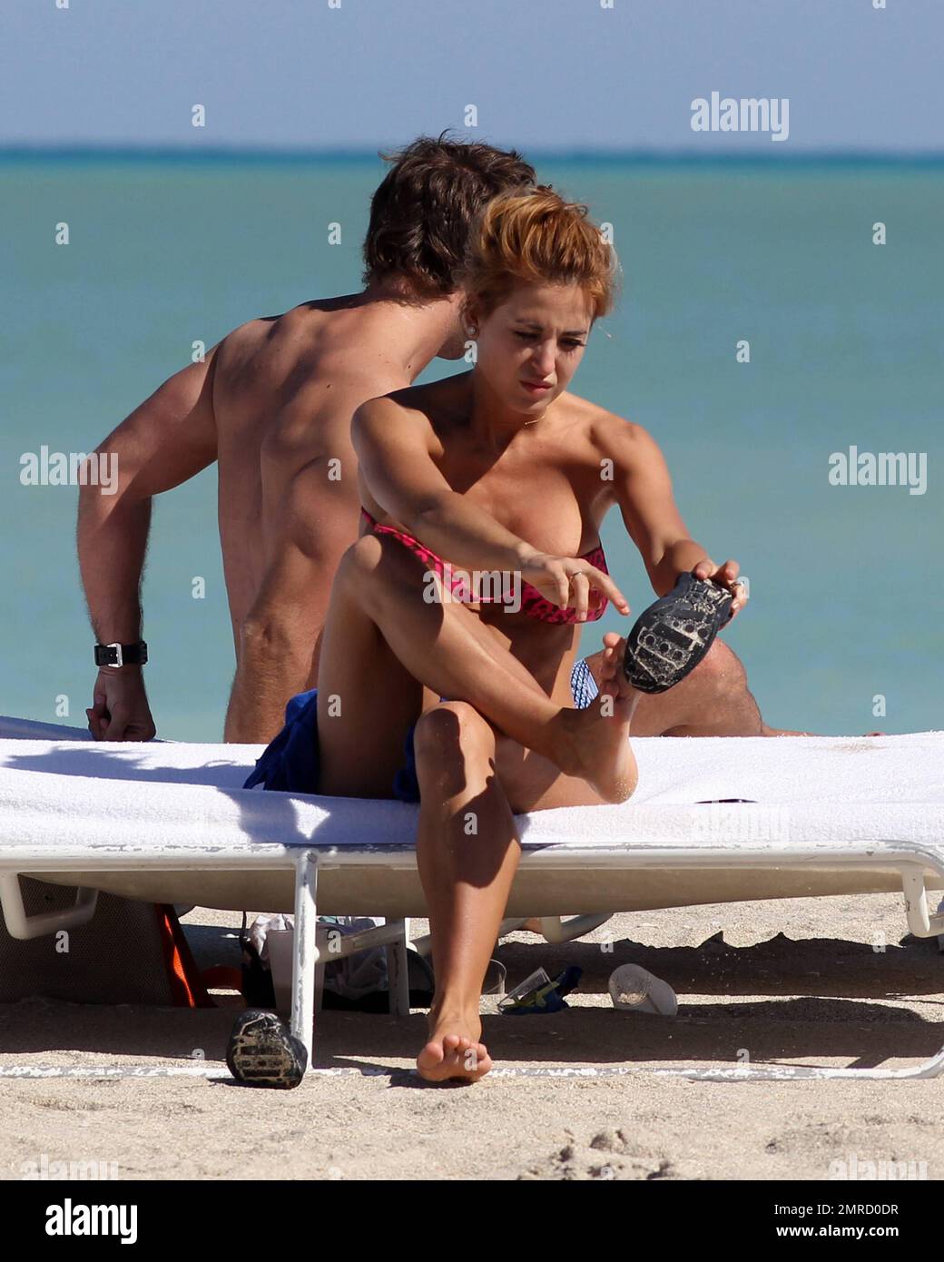 Argentine model, dancer and vedette, Jessica Cirio shows a bit more than intended as her bikini top slips while getting dressed. Cirio wore a pink patterned bikini while soaking up the sun with a male companion before heading back to their hotel. Miami Beach, FL. 29th October 2012. Stock Photo