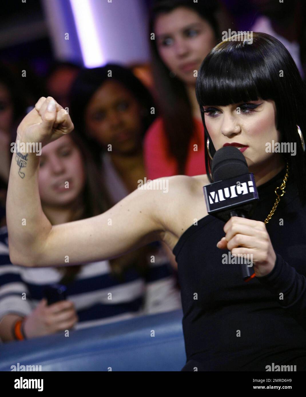 Wearing a black unitard with one black leg and a white one with a black squiggle down the front, singer Jessie J performs and answers questions during an appearance on 'Much Music.' Jessie seemed full of life during her question-and-answer session, making silly faces for the cameras and showing off her 'Stand Up' tattoo. During her performance, she made some 'tongue-in-cheek' faces, sipped from a bottle of water and put on a show that seemed to be loved by all the fans in attendance. Toronto, ON. 4/25/11. Stock Photo