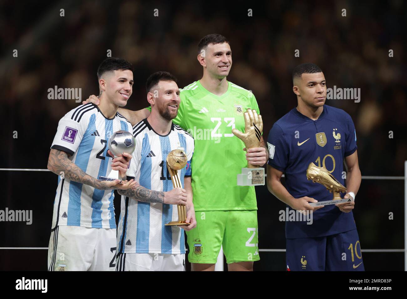 Enzo Fernandez, Lionel Messi, Emiliano Martinez (Argentina), Kylian Mbappe (France) are seen with trophies during the FIFA World Cup Qatar 2022 Final match between Argentina and France at Lusail Stadium. Final score: Argentina 3:3 (penalty 4:2) France. Stock Photo