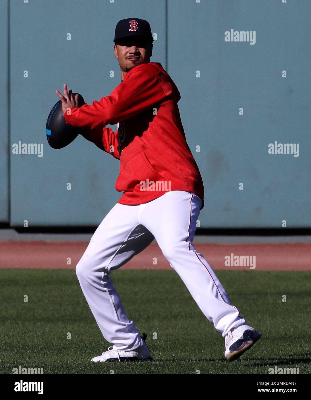 Boston Red Sox right fielder Mookie Betts throws a football during
