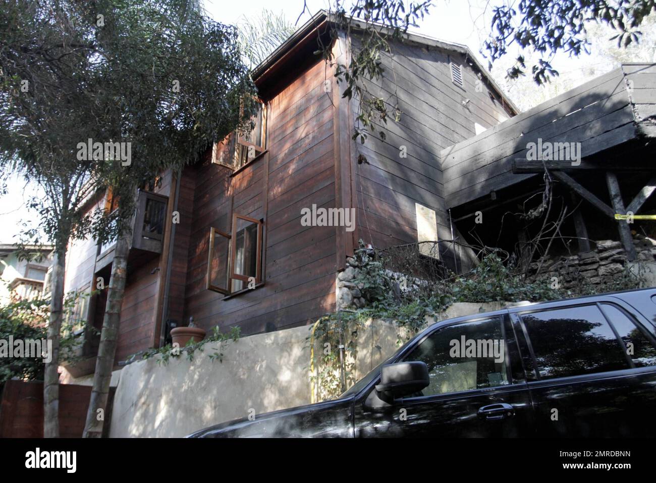 General views of rock legend Jim Morrison's former home after it was damaged by fire. The 1922 Hollywood home reportedly caught fire at 1:20 a.m. after flames spread from a nearby car. The blaze took 35 minutes to contain and was battled by 56 firefighters. According to the reports, the fire was one of 19 overnight arson attacks that plagued Hollywood and West Hollywood early Friday morning. The home was where Morrison wrote The Doors' album 'Waiting for the Sun' and portions of 'The Soft Parade.' The street on which it is located was the insporation for the song 'Love Street,' which was featu Stock Photo