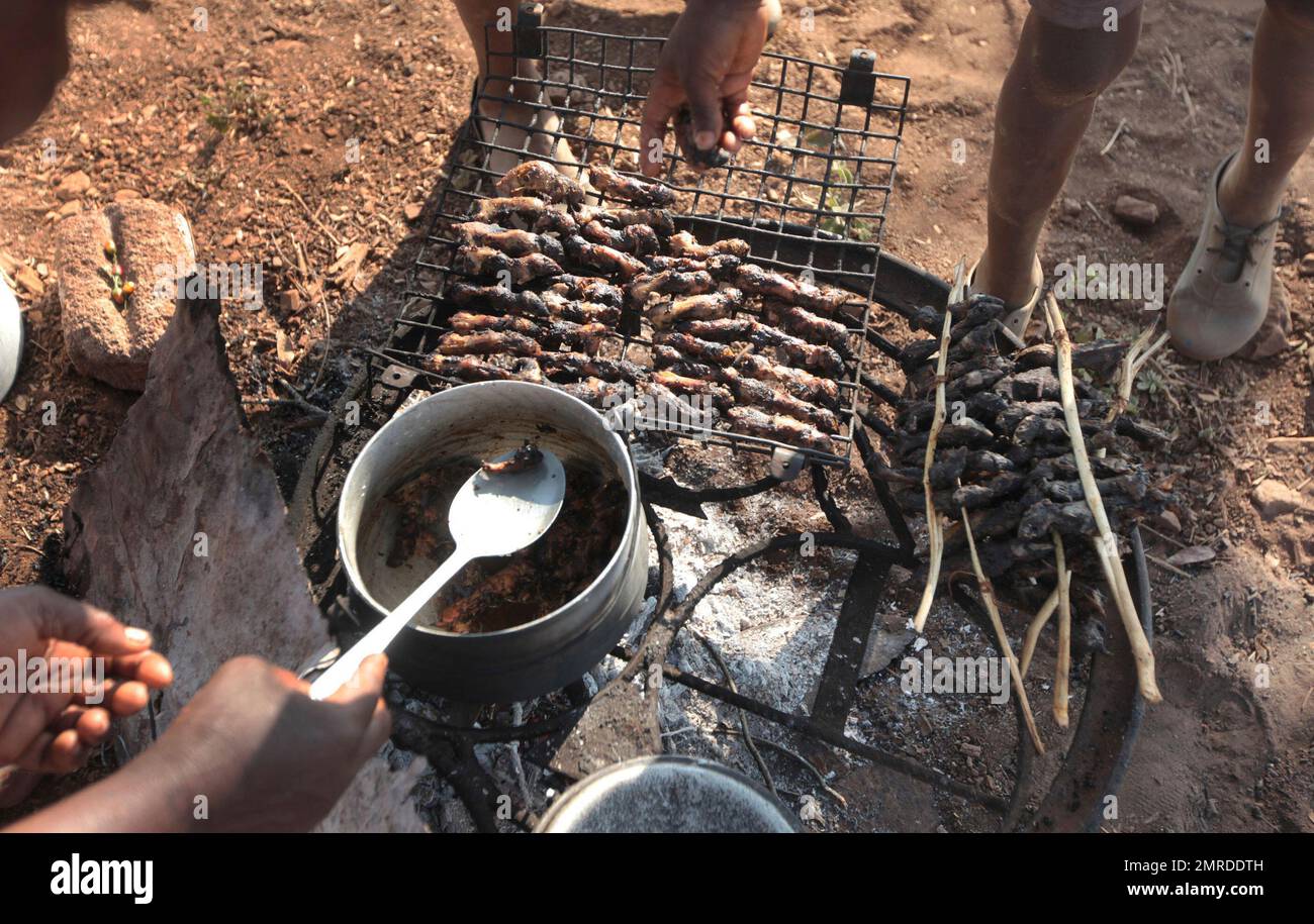 In this photo taken Saturday, Sept. 23, 2017, mice are cooked on a fire