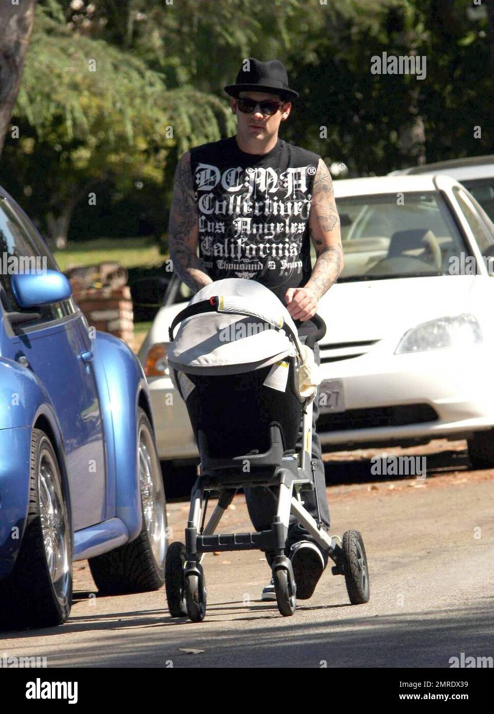 Joel Madden took baby Harlow for a walk in the stroller this morning