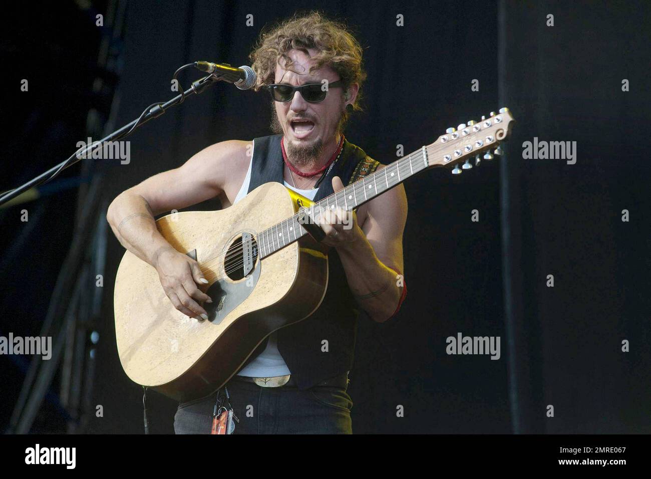 Australian musician John Butler sings and plays the guitar and bango during  a performance with the funk rock and bluegrass band John Butler Trio at the  annual Big Day Out music festival
