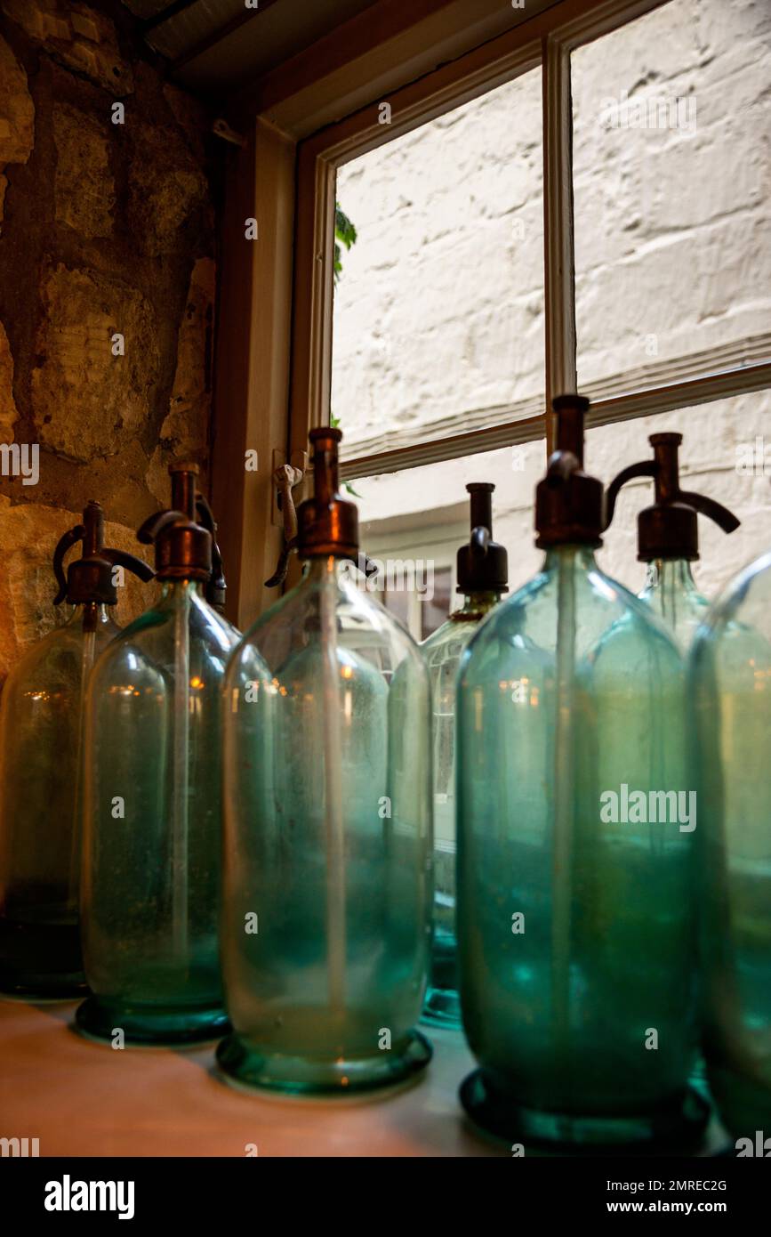 Antique seltzer bottles at the Lion Inn in Winchcombe, England, Cotswolds District. Stock Photo