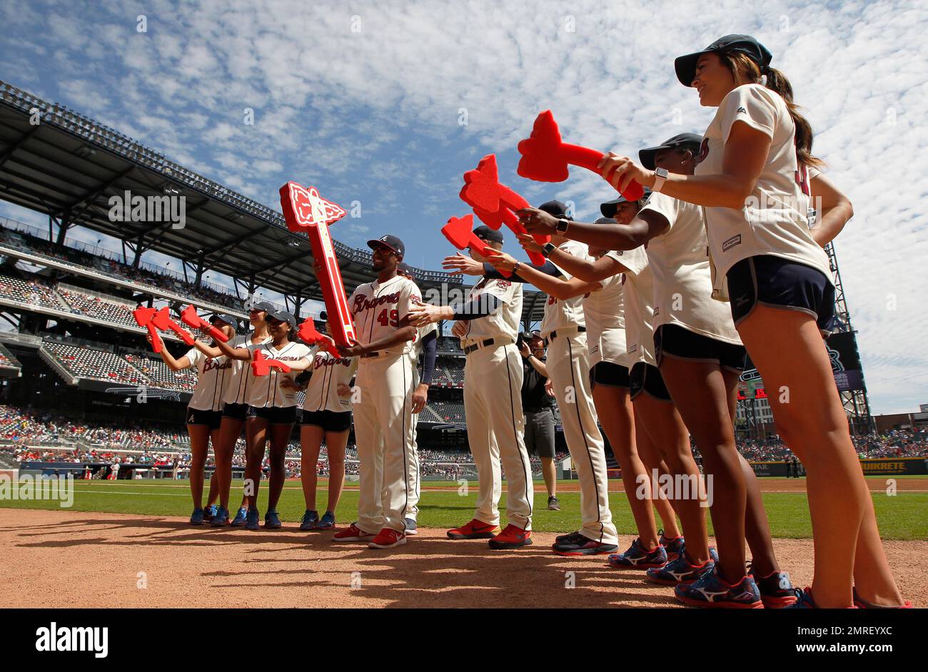 Philadelphia Phillies ball girls in short shorts do a dance on the field  with the Philadelphia Phantic to cheer up the crowd as heavy rain falls  durning fifth inning World Series game