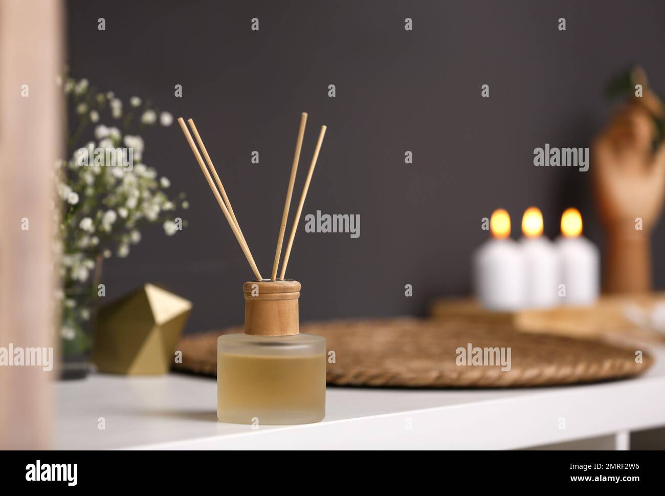Reed diffuser on white table in modern bathroom Stock Photo Alamy