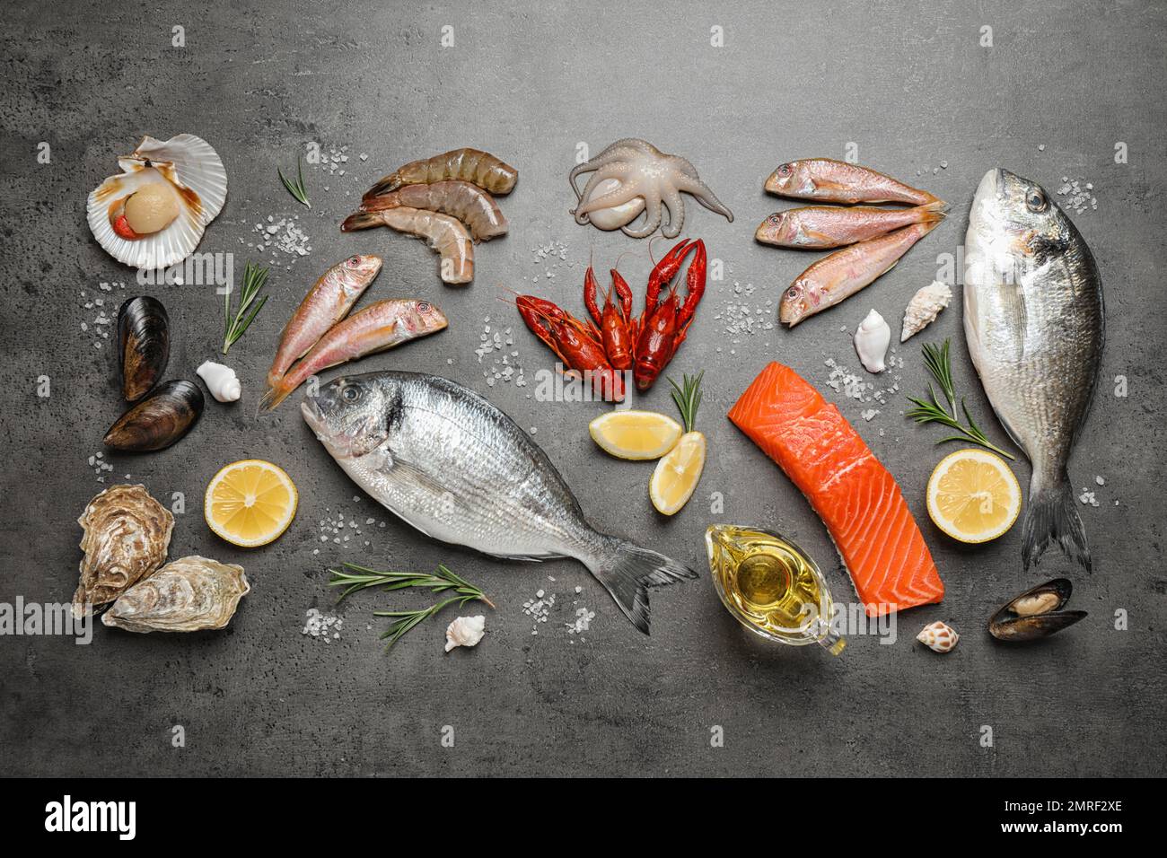 Fresh fish and seafood on grey table, flat lay Stock Photo - Alamy