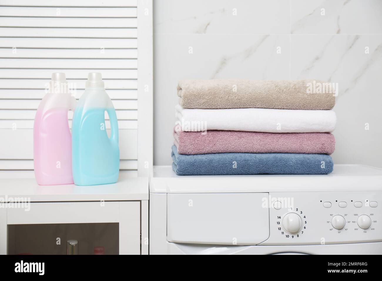 Stack of fresh towels and detergents in laundry room Stock Photo - Alamy