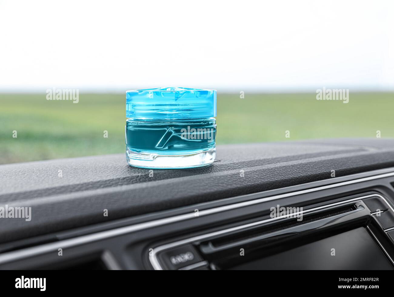 Stylish air freshener on dashboard in car Stock Photo Alamy