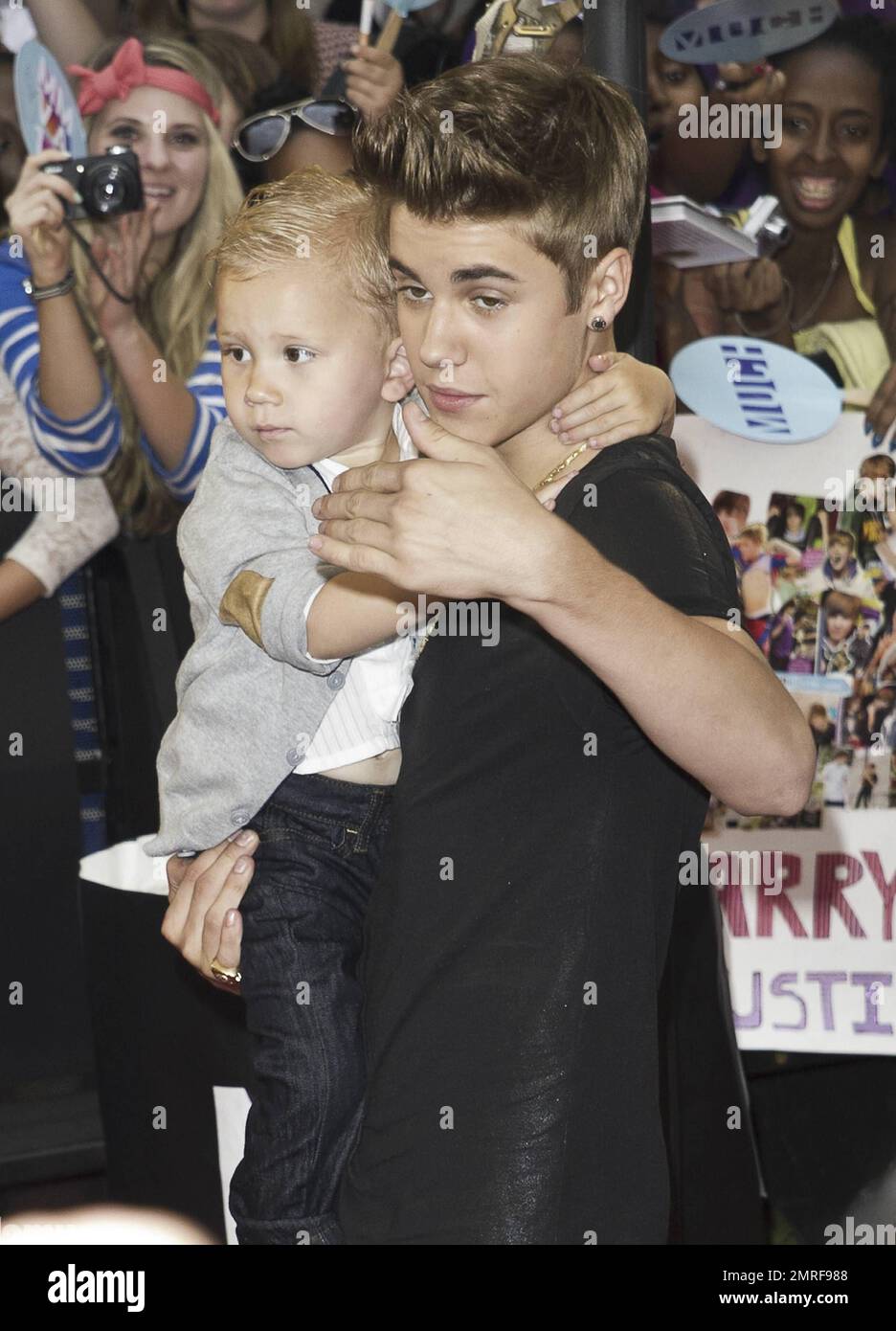 Justin Bieber carries baby brother Jaxon at the 23rd Annual MuchMusic ...