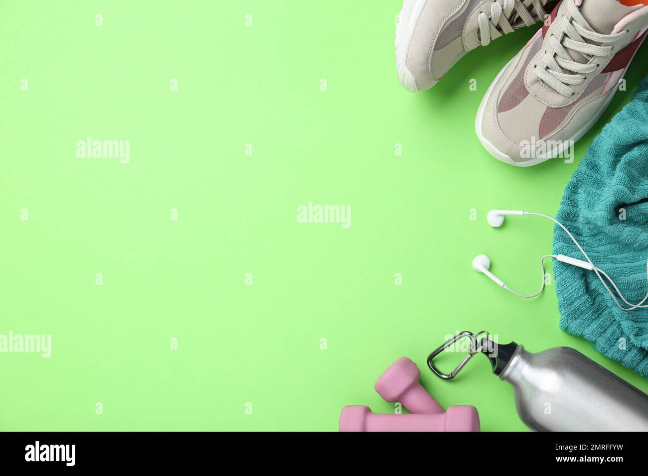 Flat lay composition with sport items on green background. Space for text Stock Photo