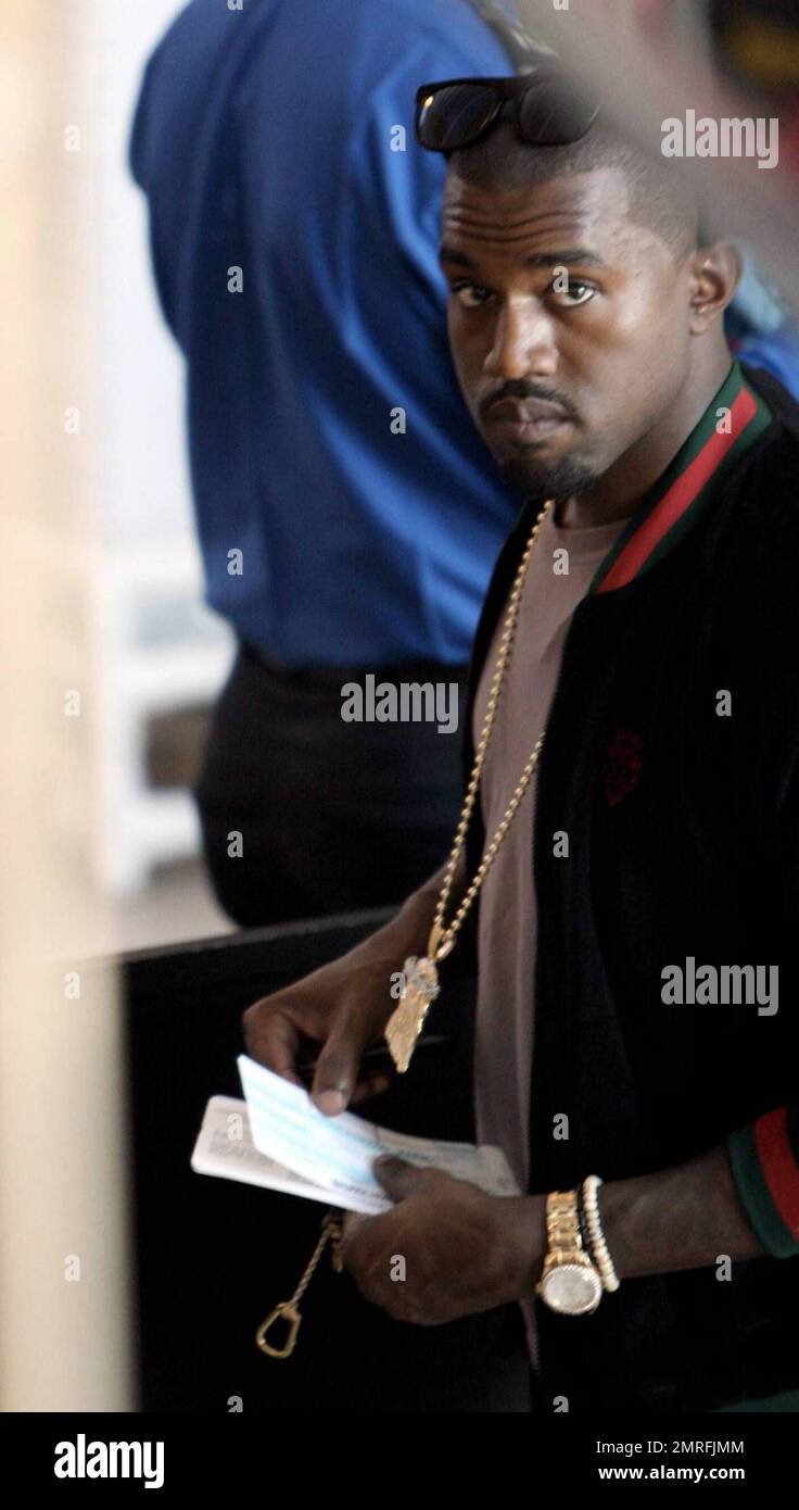 Exclusive!! Kanye West has to remove his shoes like everyone else as he  goes through the security gate at LAX. Los Angeles, CA, 06/06/09 Stock  Photo - Alamy