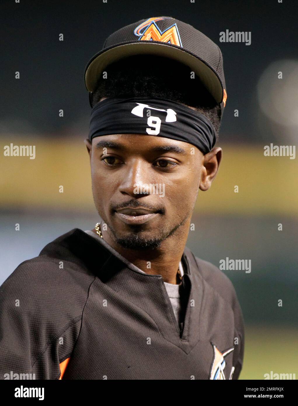 Miami Marlins' Dee Gordon puts on his batting gloves during batting practice  before the start of a baseball game against the Washington Nationals,  Tuesday, June 20, 2017, in Miami. (AP Photo/Wilfredo Lee