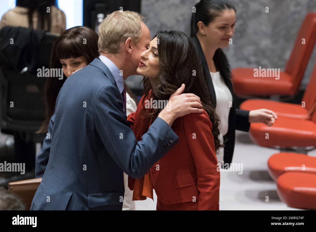 Human rights lawyer Amal Clooney, right, greets British Ambassador to