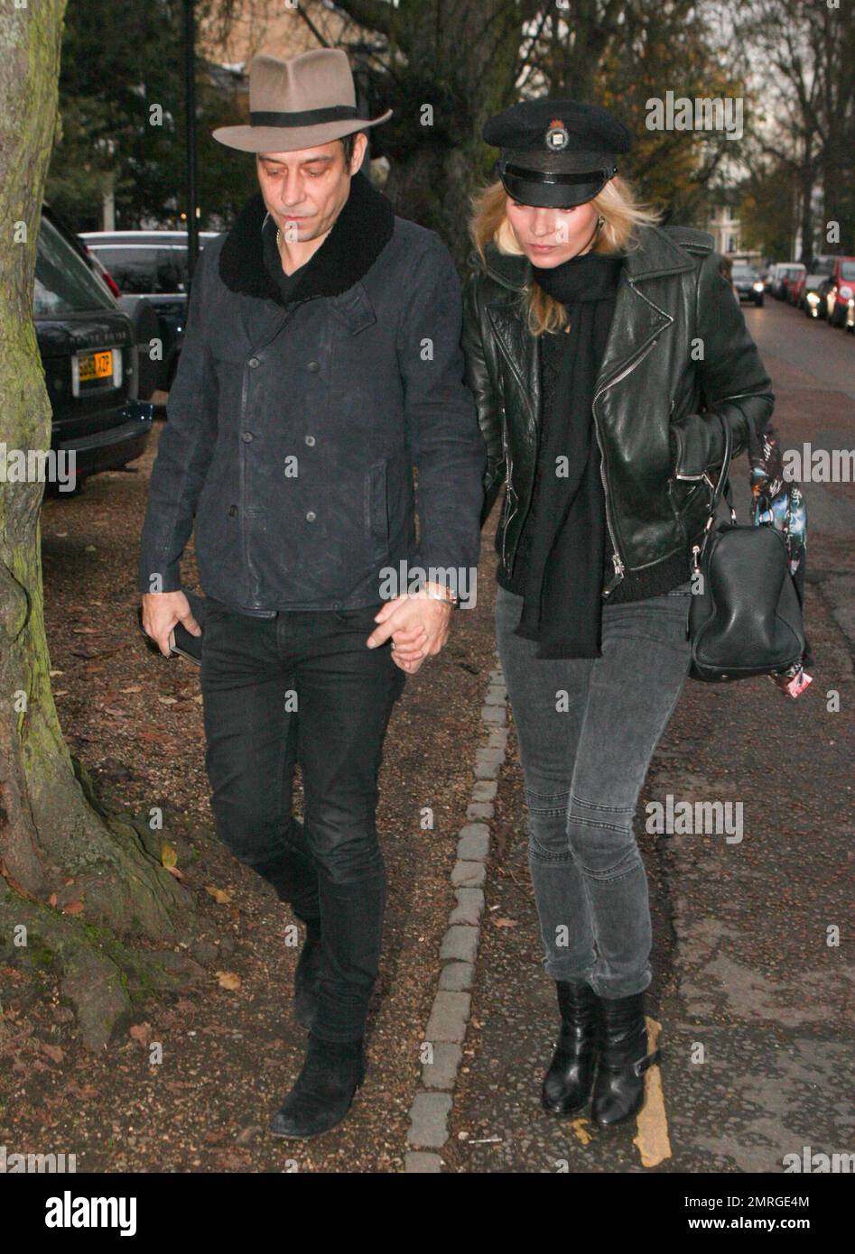 Supermodel Kate Moss and rocker husband Jamie Hince of 'The Kills' were seen walking hand in hand as they arrived at their new home in Hampstead. Its been reported that Kate paid out an estimated $30,000 at The Hoping Foundation Benefit to hear Boy George sing her favorite song. Kate got up from her table and joined Boy George in singing 'Do You Really Want To Hurt Me,' after shelling out the money for the privilege. London, UK. 23rd November 2011.   . Stock Photo