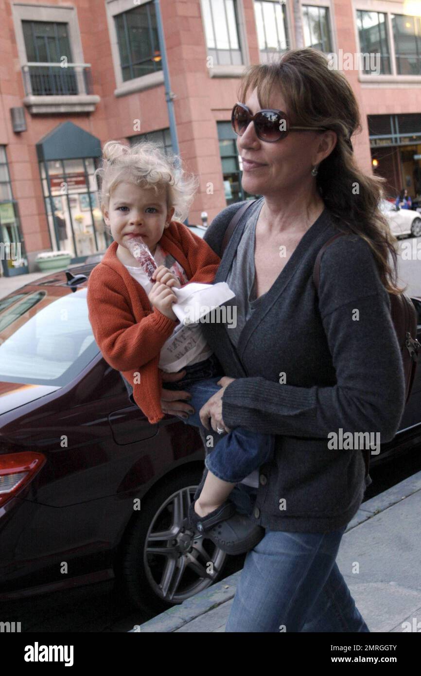 Best known for her role as Peggy Bundy on the hit series 'Married with Children,' actress and singer Katey Sagal carries her daughter Esme Louise Sutter to the car after a doctor's appointment in Beverly Hills, CA. 1/13/10.     . Stock Photo