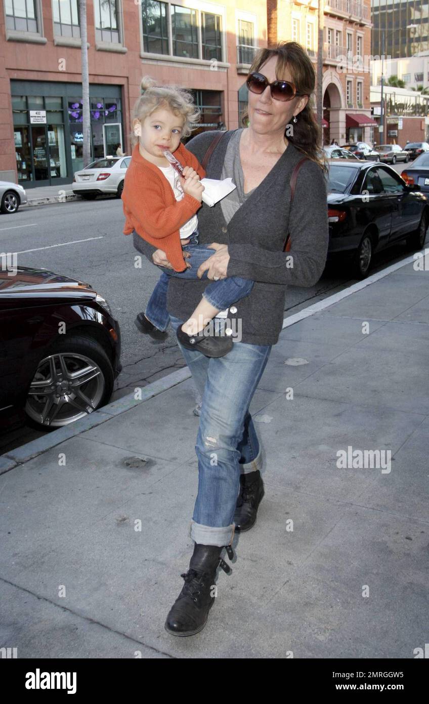 Best known for her role as Peggy Bundy on the hit series 'Married with Children,' actress and singer Katey Sagal carries her daughter Esme Louise Sutter to the car after a doctor's appointment in Beverly Hills, CA. 1/13/10.   . Stock Photo