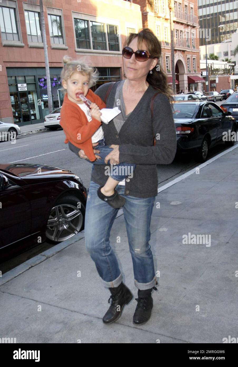 Best known for her role as Peggy Bundy on the hit series 'Married with Children,' actress and singer Katey Sagal carries her daughter Esme Louise Sutter to the car after a doctor's appointment in Beverly Hills, CA. 1/13/10.   . Stock Photo