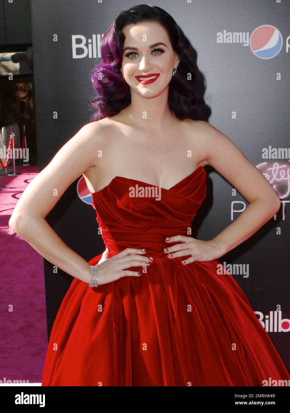Singer Katy Perry wears a lovely red strapless dress with red high heels as  she walks the pink carpet of the L.A. Premiere of her 3D-Concert  Documentary "Katy Perry: Part Of Me"