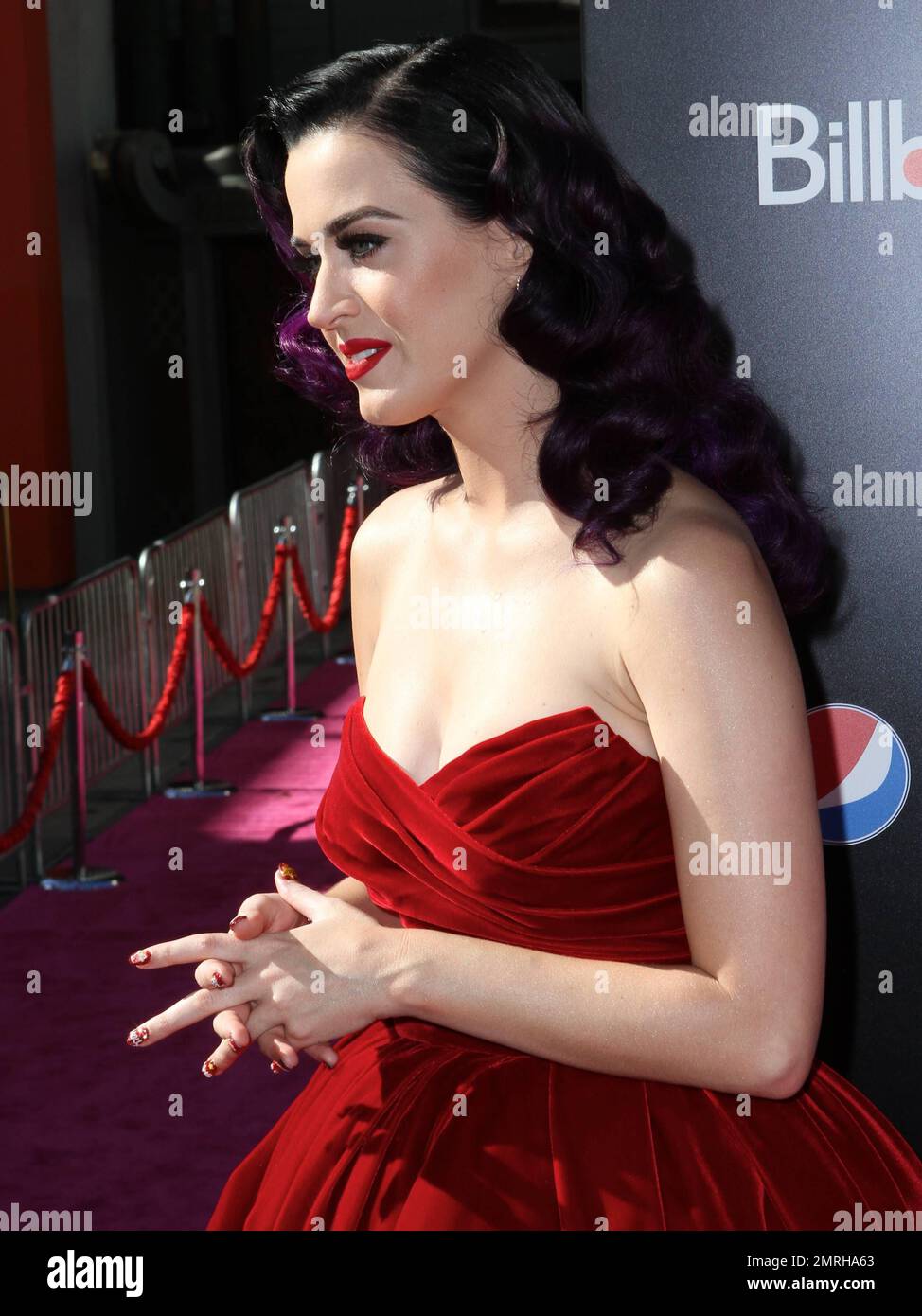 Singer Katy Perry wears a lovely red strapless dress with red high heels as  she walks the pink carpet of the L.A. Premiere of her 3D-Concert  Documentary "Katy Perry: Part Of Me"