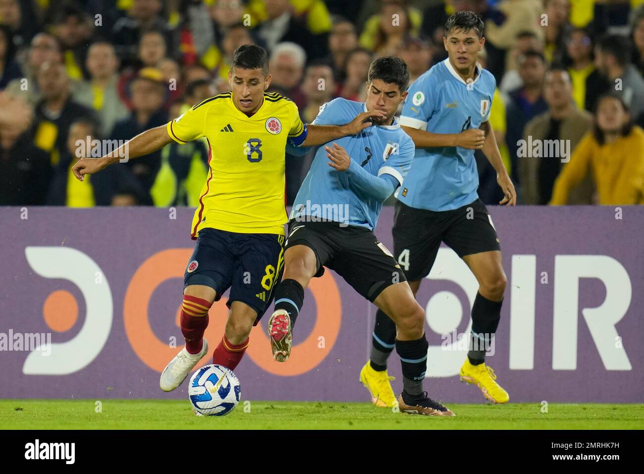 Colombia's Gustavo Puerta, left, and Uruguay's Renzo Sanchez fight for