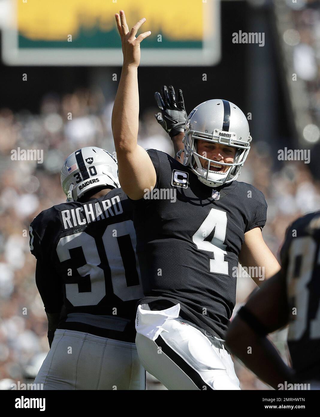 Oakland Raiders quarterback Derek Carr (4) celebrates with running back