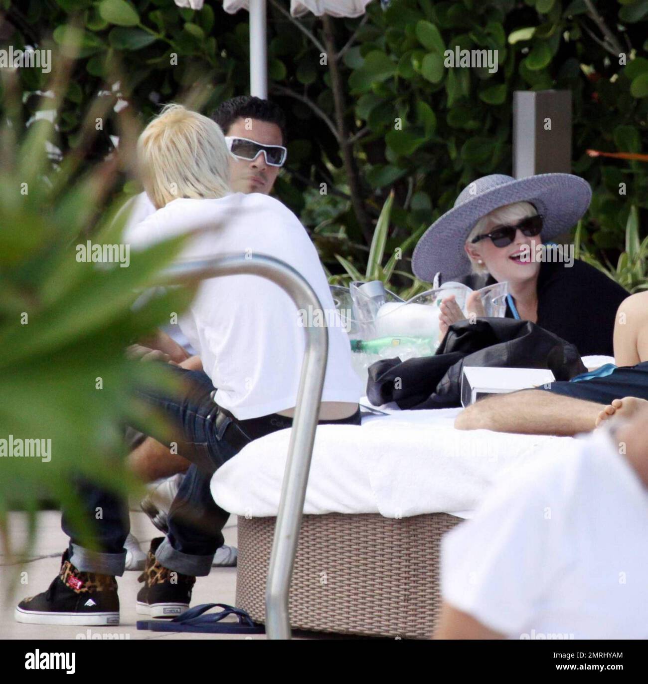 Kelly Osbourne chills out in a cabana poolside with fiance Luke Worrall ...
