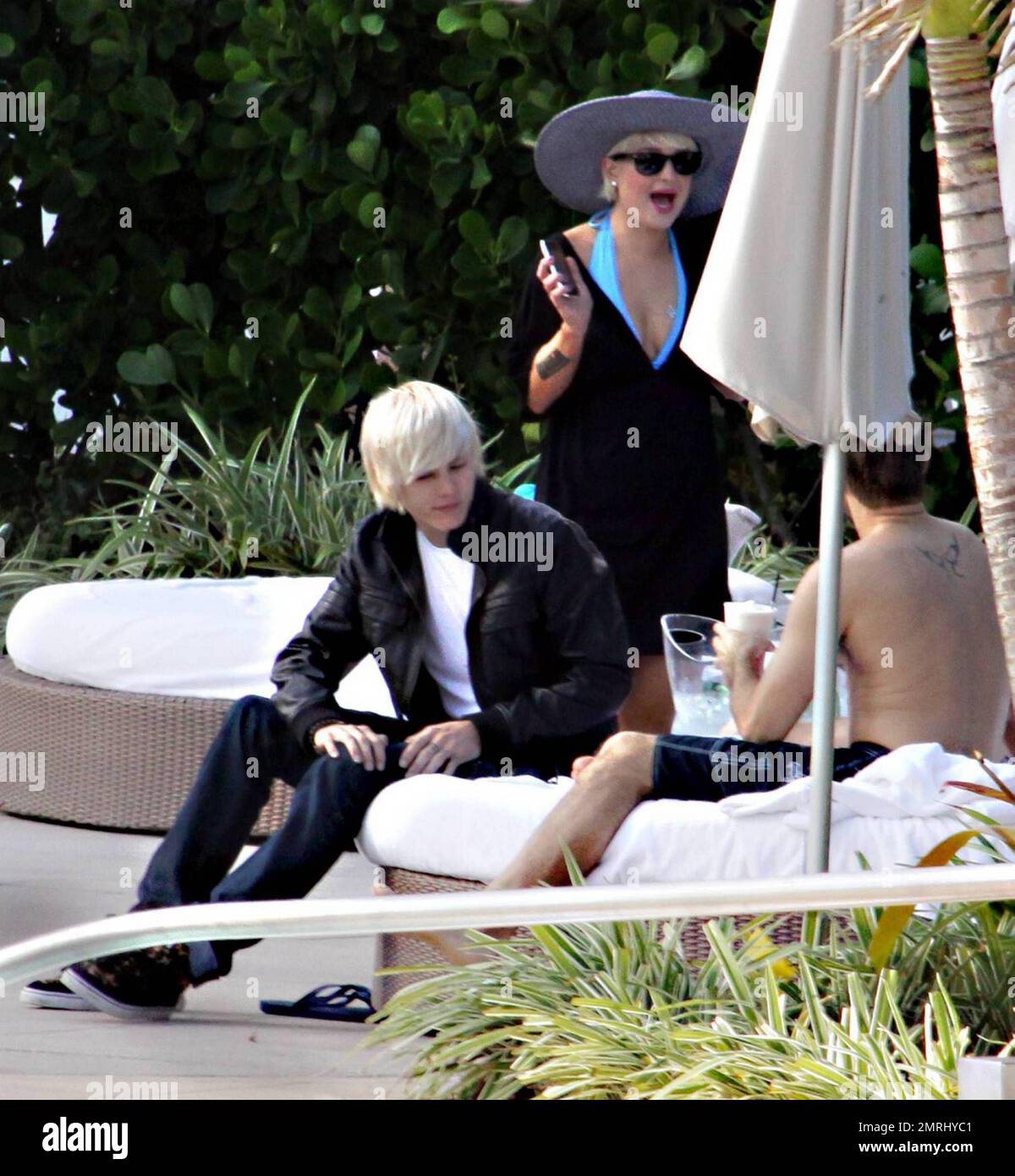 Kelly Osbourne chills out in a cabana poolside with fiance Luke Worrall ...