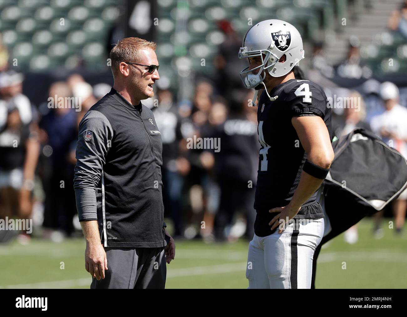 Oakland Raiders offensive coordinator Todd Downing, left, talks with ...